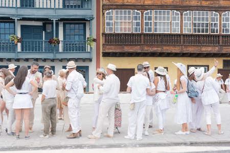 SANTA CRUZ DE LA PALMA, CANARY ISLANDS, SPAIN - MARCH 04, 2019:  People enjoying in Los Indianos Party during the carnival in Santa Cruz de La Palma. In this party people wear white clothes and have fun dancing Cuban music and lacing talcum powder.のeditorial素材