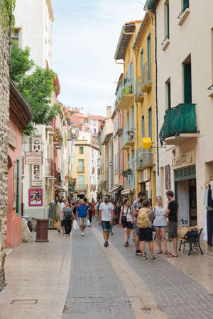 COLLIURE, FRANCE: SEPTEMBER 18th, 2018: Tourists walking through the beautiful streets of Collioure,...