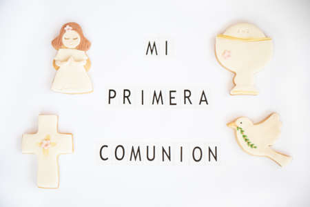Concept: First communion. Poster announcer in Spanish. Fondant cookies with related drawings. White background.の写真素材