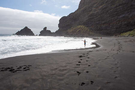 Boy jumping in Nogales beach  in a sunny day (La Palma, Canary Islands, Spain)の写真素材