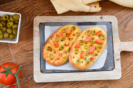 variety of different focaccia, with pumpkin, carrot and beet, on a rustic table. Traditional Italian...