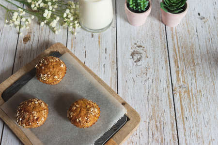 Fresh homemade delicious carrot muffins decorated with oat flakes and brown sugar on rustic table, copy space, top viewの写真素材