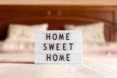 Lightbox with text: home sweet home on bed, copy space.の写真素材