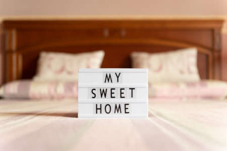 Lightbox with text: my sweet home, on the bed, copy space.の写真素材