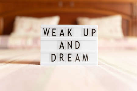 Lightbox with text: wake up and dream, on the bed, copy space.の写真素材