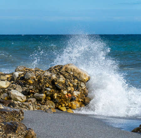 sea waves crashing on the rocksの写真素材