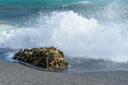 sea waves crashing on the rocksの写真素材