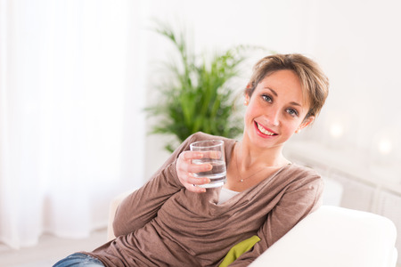 cheerful young women drinking mineral waterの写真素材