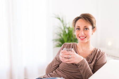 cheerful young women drinking mineral waterの写真素材