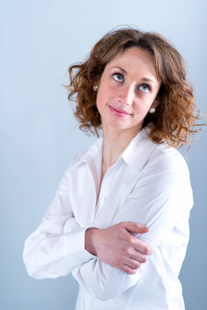 portrait of a beautiful and sexy young woman on light backgroungの写真素材
