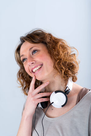 isolated portrait of a beautiful young woman playing with tablet computerの写真素材