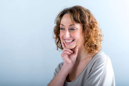 portrait of a beautiful and sexy young woman on light backgroungの写真素材
