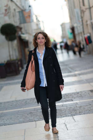 beautiful young woman walking and shoping downtownの写真素材