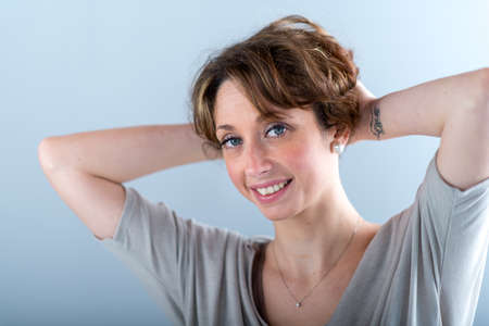 portrait of a beautiful and sexy young woman on light backgroungの写真素材