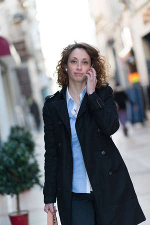 beautiful young woman walking and shoping downtownの写真素材