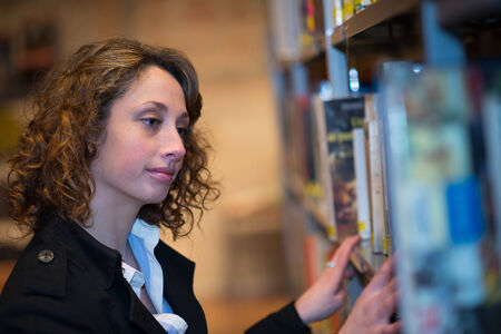 beautiful young woman  reading books in public libraryの写真素材