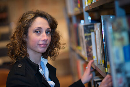 beautiful young woman  reading books in public libraryの写真素材