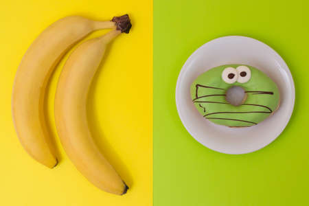Concept of obesity among children. Unhealthy lifestyle. What to choose fruit of junk food? Top viewの写真素材