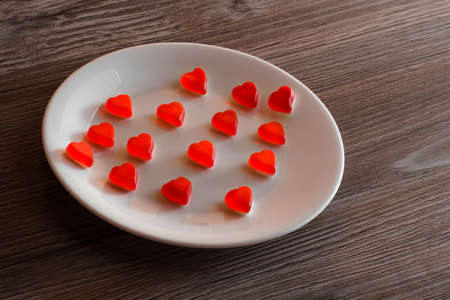 A plate of jelly candies in shape of heartの写真素材