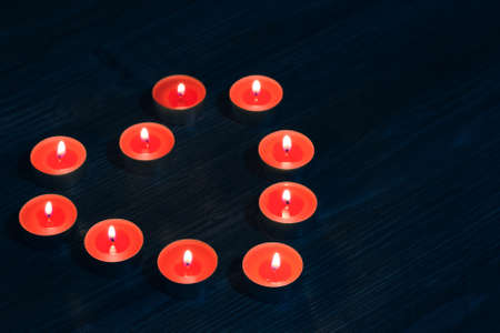 Candles in shape of red heart on dark wooden backgroundの写真素材