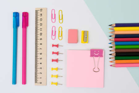 Top view of school supplies. Set of stickers, paper clips and pins, color pencils, pens and rulerの写真素材