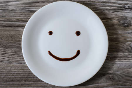 A plate with a smiling face on it written with chocolateの写真素材