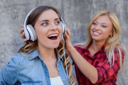 Age audio fan jeans red checkered shirt teen trend white urban swag wow omg concept. Close up portrait of crazy pretty impressed beautiful lady listening to cool  favorite track tune with open mouthの写真素材