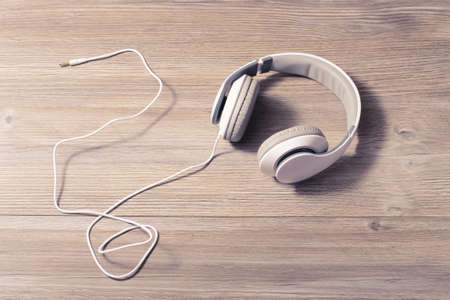 White headphones on a table の写真素材