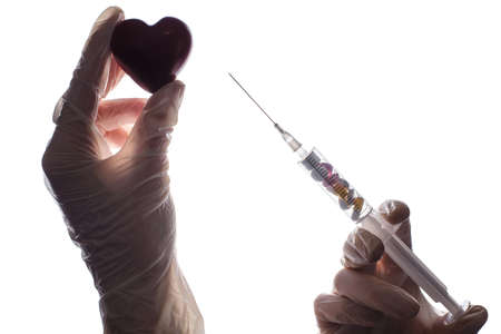 Close up photo of hands in latex gloves make give injection for heart.の写真素材