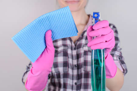 Housekeeping cloth concept. Close up portrait of charming beautiful lady cleaning window using...