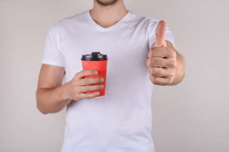 Ok satisfied good nice great advertising ad nice mocha concept. Cropped close up photo of happy glad guy making giving finger up to camera isolated grey gray background copy spaceの写真素材