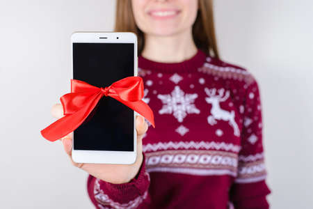 Black monitor perfect surprise concept! Cropped close up photo of happy smiling woman showing cell...