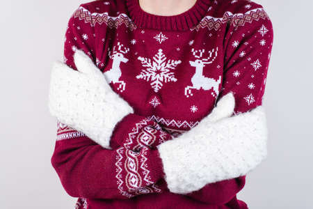 Cropped close up of unhappy shivering teenager hugging herself isolated on gray background copy spaceの写真素材
