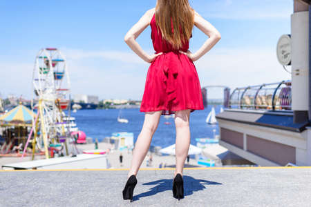 Rear back behind low angle close up view photo portrait of beautiful confident queen princess on top looking at parkの写真素材