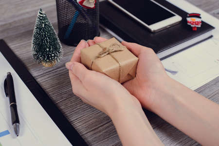 Side profile point of view first person close up overhead view photo of excited cheerful ecstatic calm lady holding wrapped in loft paper want to open unpackの写真素材
