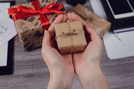 Pov high angle first person overhead view close up photo of beautiful red ribbon bow paper wrapped...