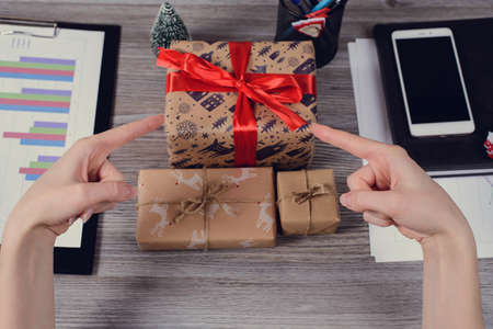 Pov high angle first person overhead view close up photo of beautiful red ribbon bow paper wrapped...