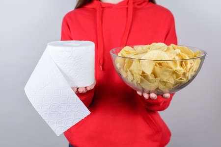 Cropped close up photo portrait of sad unhappy upset people person showing holding big large glass bowl plate with chips isolated gray backgroundの写真素材