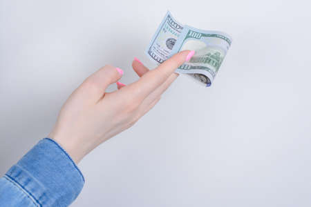 Cropped closeup side profile photo portrait of hands holding showing one hundred dollars isolated...