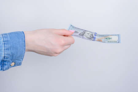 Cropped closeup side profile photo portrait of hands holding showing one hundred dollars isolated...