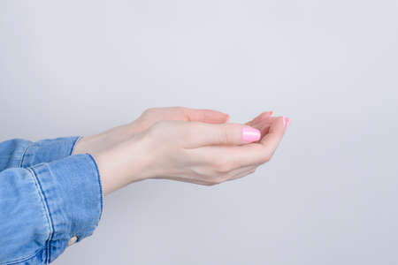 Side profile closeup cropped photo of cupped hands asking for forgivennes isolated grey backgroundの写真素材