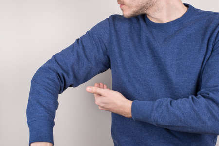 Perfect nice smell reliable deodorant concept. Cropped closeup photo of satisfied guy checking smell...