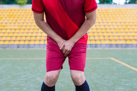 Cropped close-up photo of human's body closing covering place between legs with palmsの写真素材