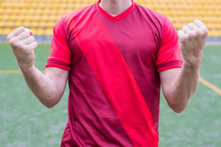 Cropped close up photo of excited happy player scoring a goal raising gesturing fistsの写真素材