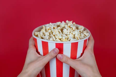 Cropped close-up top above overhead high angle view photo of tasty yummy delicious fresh container with popcorn isolated bright backgroundの写真素材