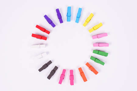 High angle view studio photo of nice colorful mini clothespins isolated on white table background...