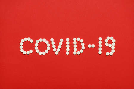 Top above overhead close up view photo of inscription of coronavirus covid-19 made of white round...