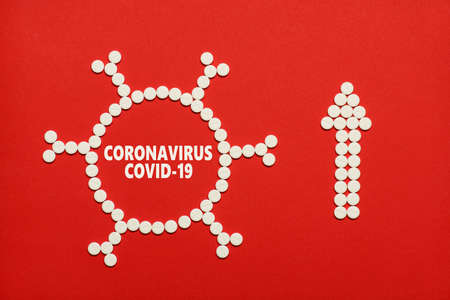 Coronavirus world spreading concept. Top above flatlay overhead closeup view photo of  tablets in shape of virus and arrow showing up isolated red color background with copy blank empty spaceの写真素材
