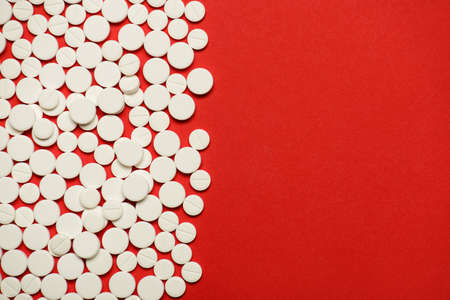 Flat lay top overhead closeup photo of small little pills with parted half place with copy empty...