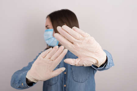 Avoiding microbes concept. Photo of frightened terrified afraid fearful teenager girl having problem want to run away from quarantine and test isolated gray backgroundの写真素材